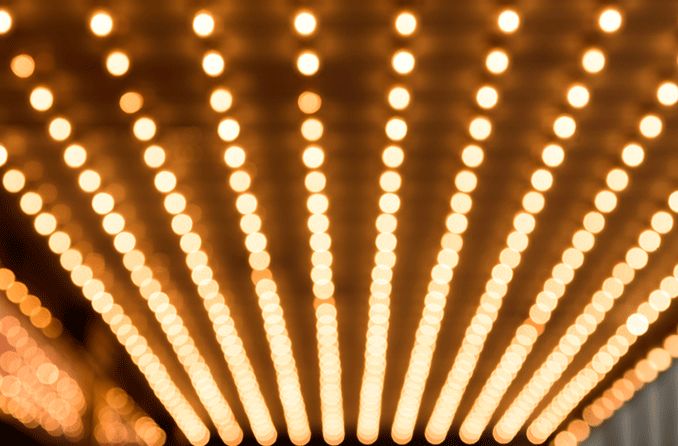 Rows of bright light bulbs on a ceiling causing a visual sensory overload