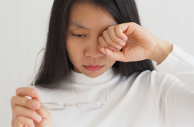 woman irritated by her eye floaters