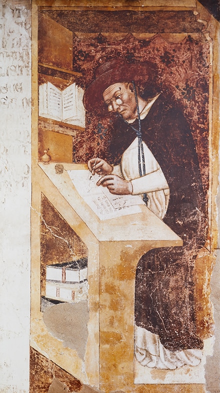 Early use of eyeglasses in history Historic artwork showing an early eyeglass wearer reading and writing.