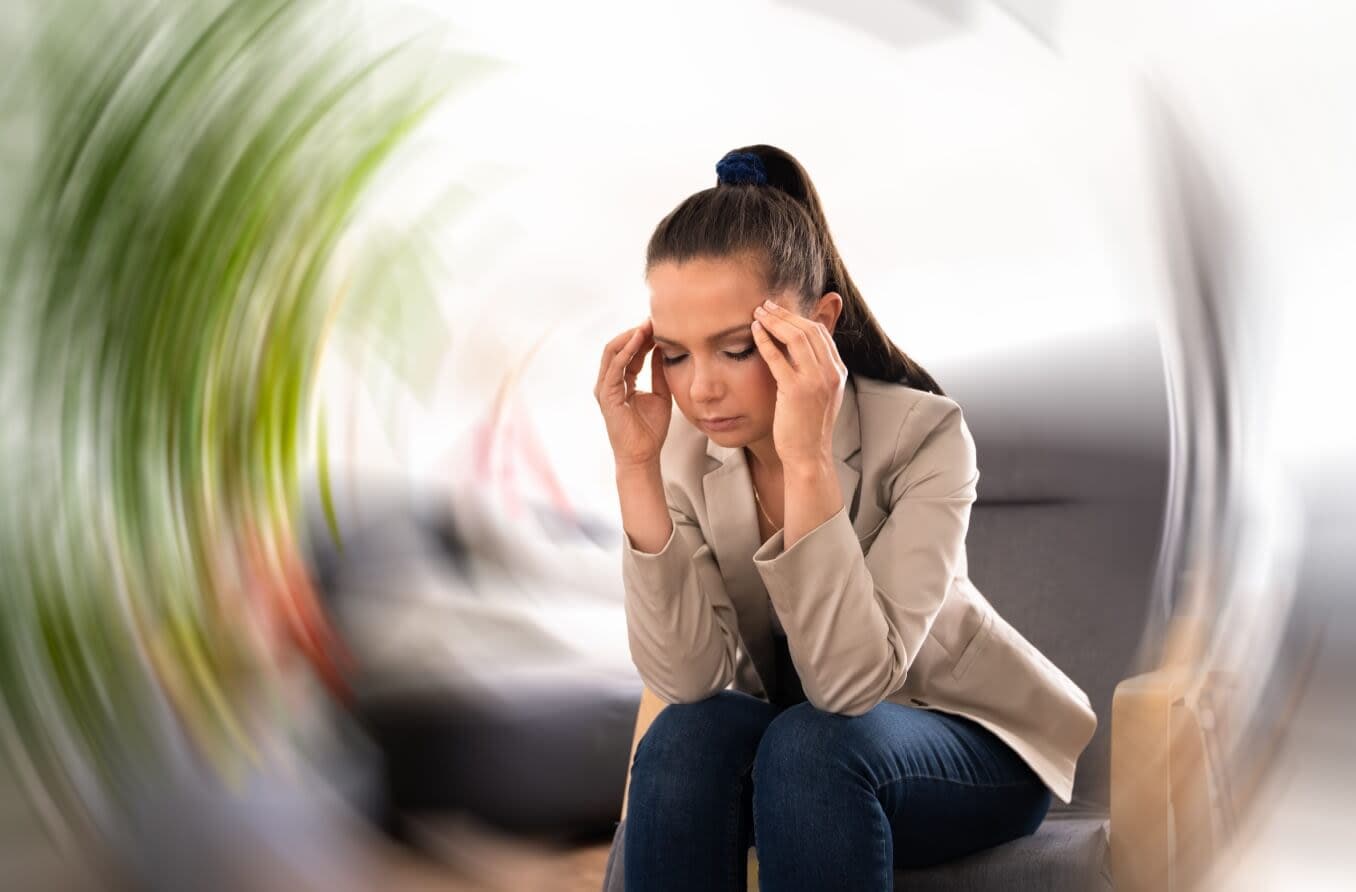 Person experiencing an episode of vertigo where the room appears to be spinning around her.