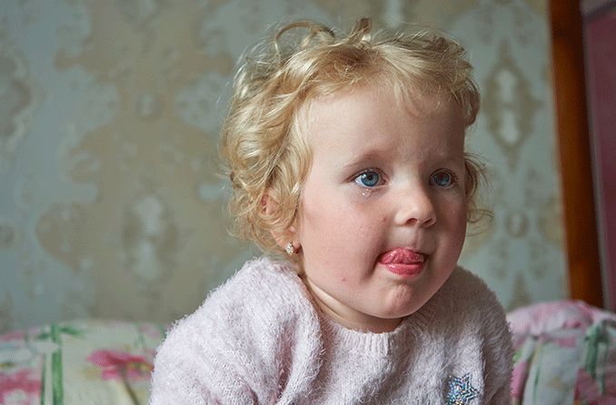 little girl licking her salty tears