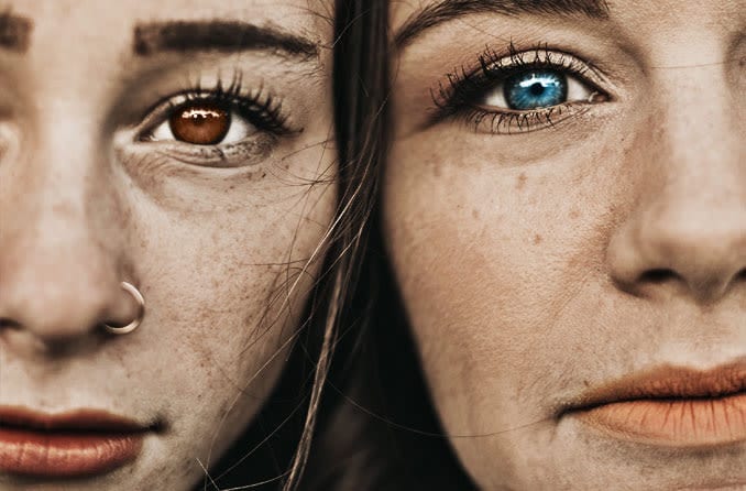 two woman with different colored eyes