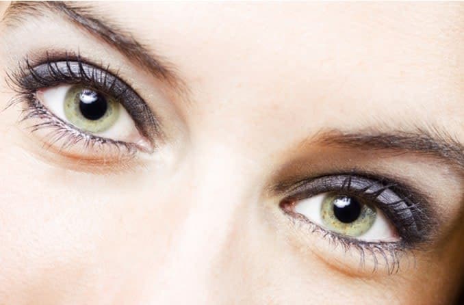 Closeup image of a woman's bright green eyes