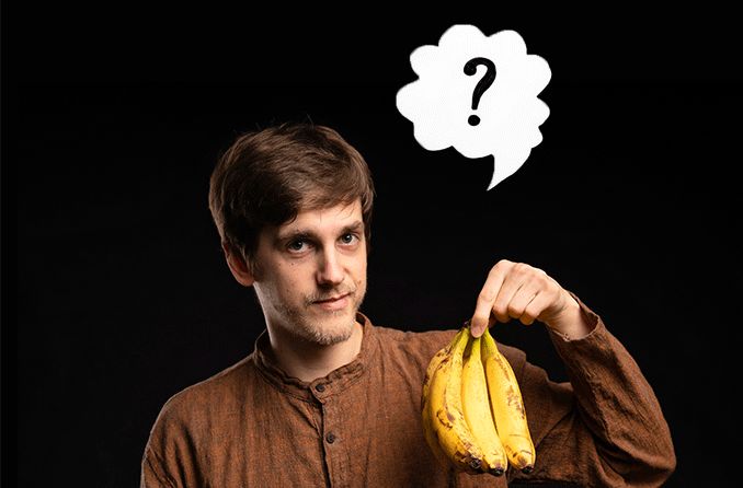 man with visual agnosia holding up banana confused as to what it is