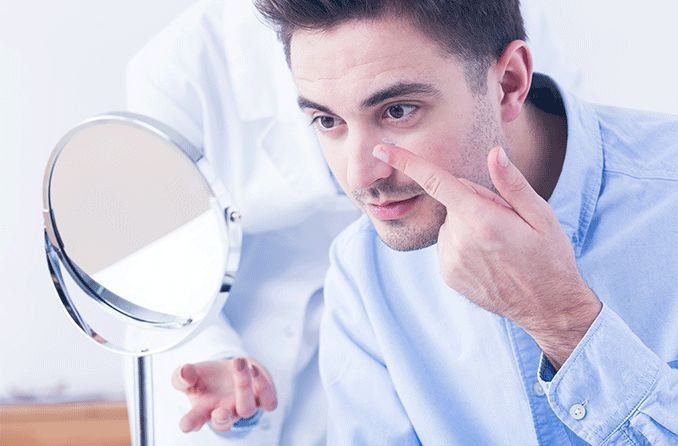 man putting in color blind contact lenses