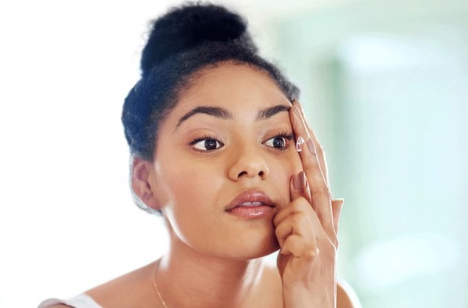 woman inserting Bausch and Lomb Ultra contact lenses