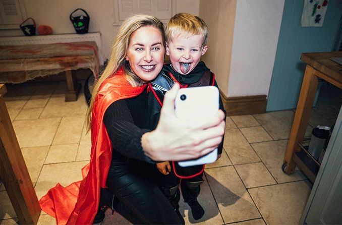 Mom wearing halloween contacts taking selfie with son