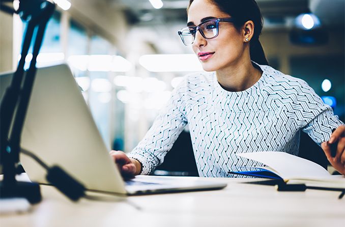 woman wearing photochromic eyeglasses as computer glasses at work