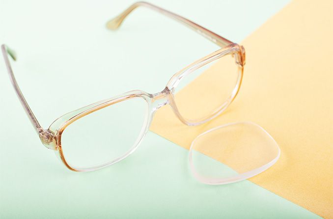 pair of eyeglasses with one lens popped out