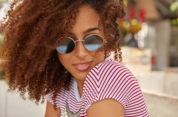 woman wearing round sunglasses outside