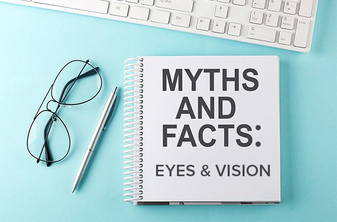 myths and facts about eyes and vision handbook next to keyboard and eyeglasses