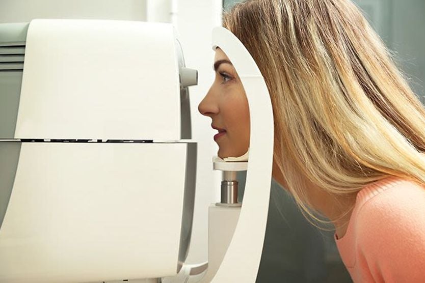 woman getting an eye pressure (intraocular) "air puff" test