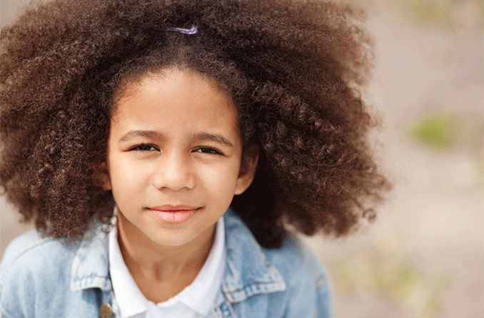 young girl outside squinting