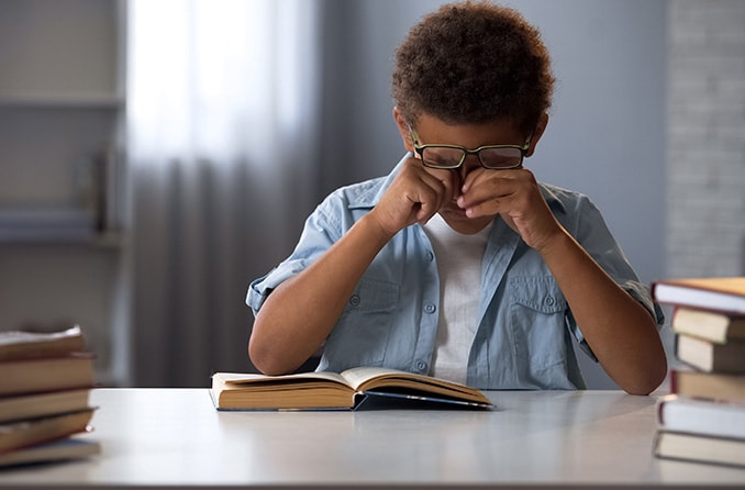 boy rubbing his eyes