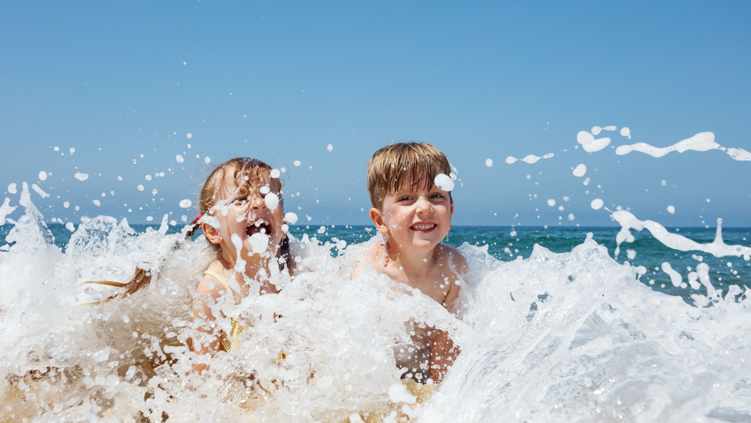 kids splashing in the ocean