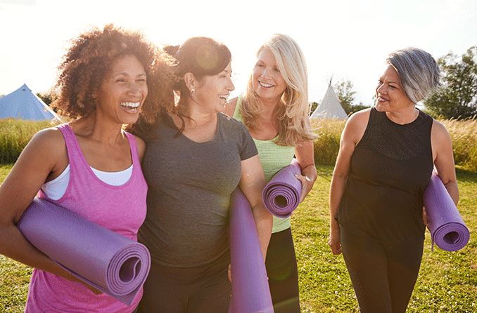 group of older woman with yoga mats
