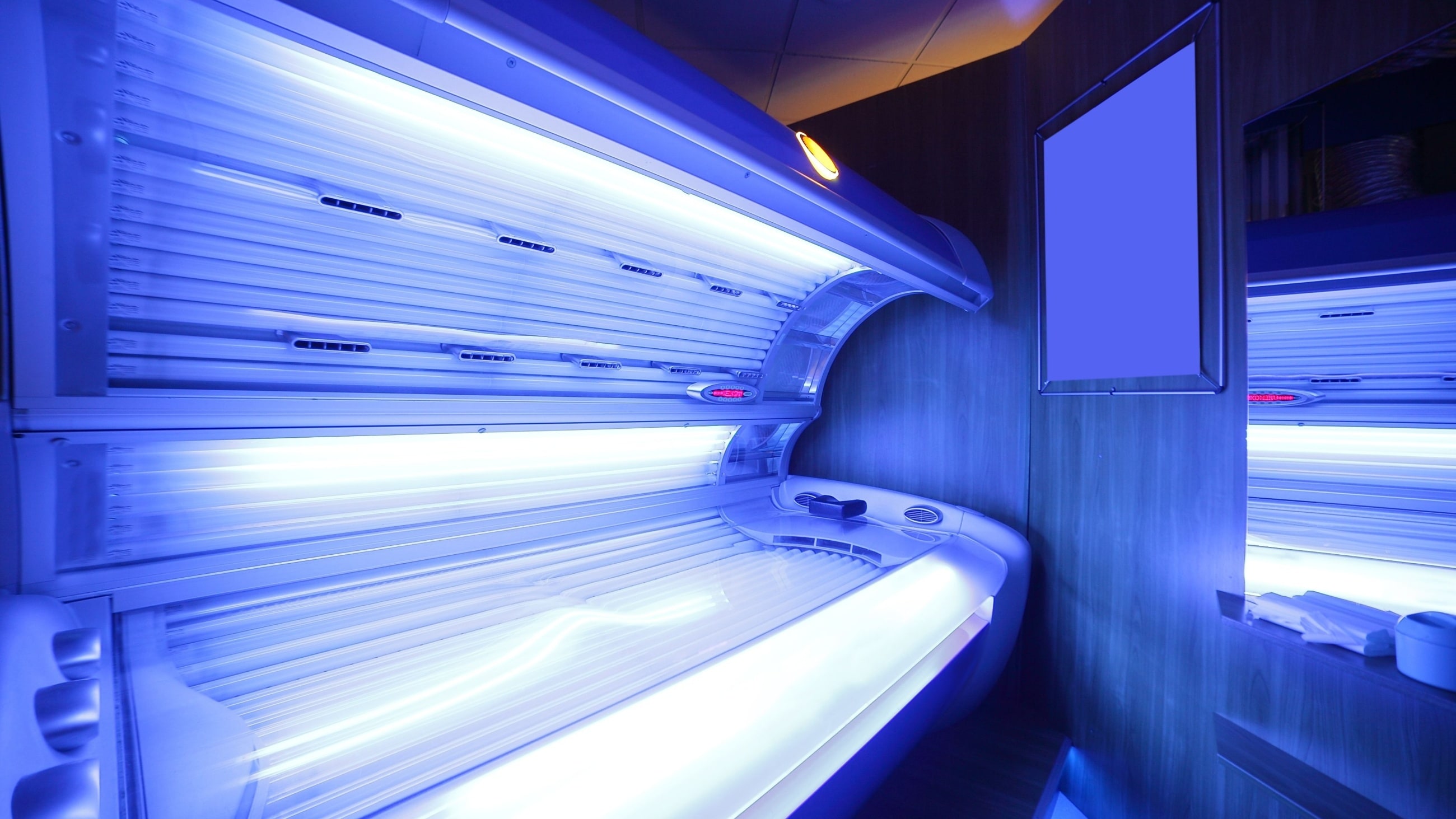 woman in tanning bed with uv light