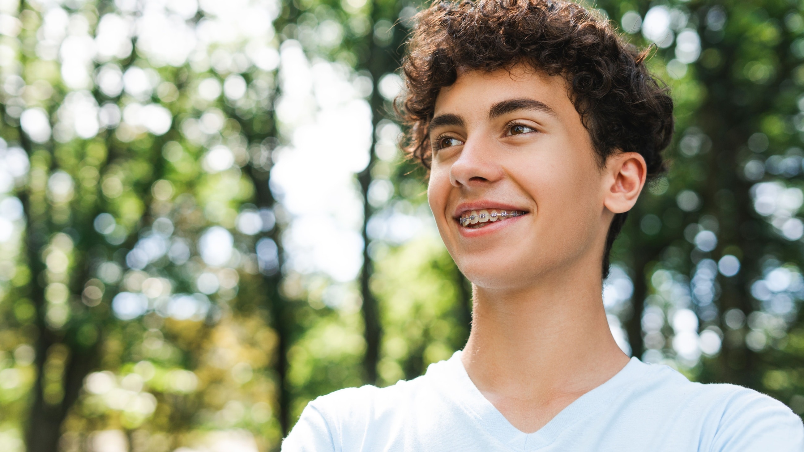 adolescent girl laying down looking through hole created through her fingers adolescent girl laying down looking through hole created through her fingers