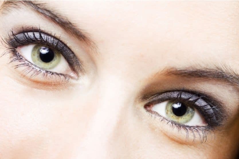 Closeup image of a woman's bright green eyes Closeup image of a woman's bright green eyes