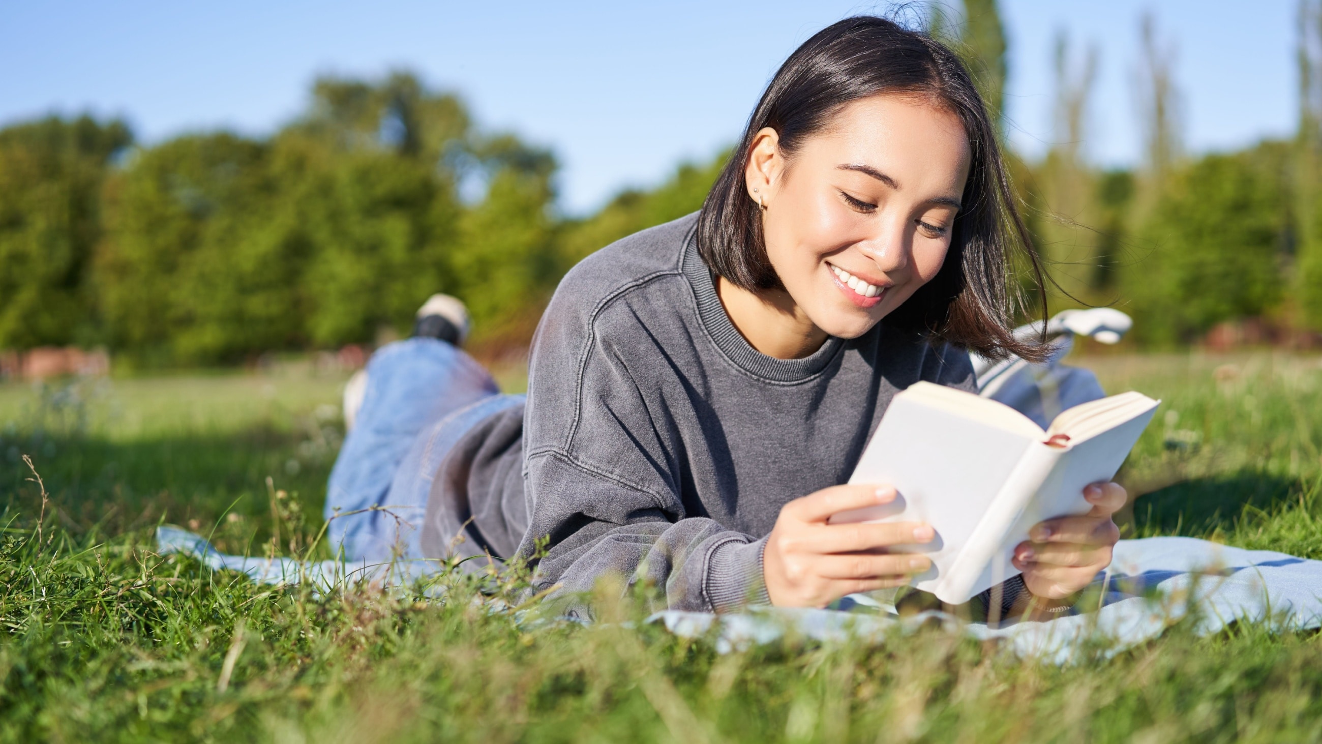 Young woman reading book outside Young woman reading book outside