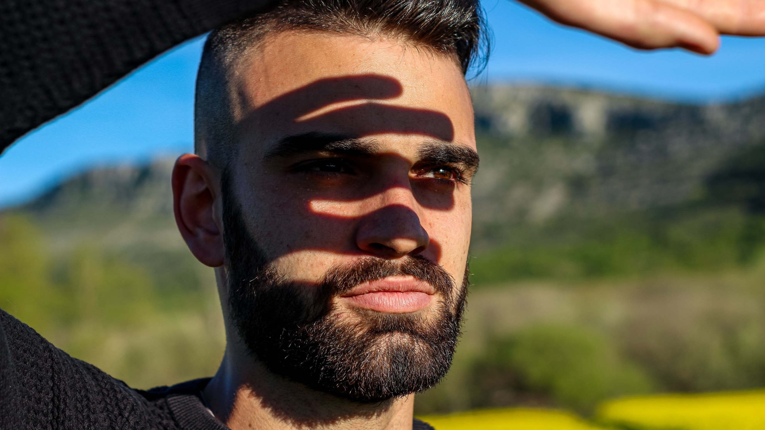 Man shielding his eyes from the sun