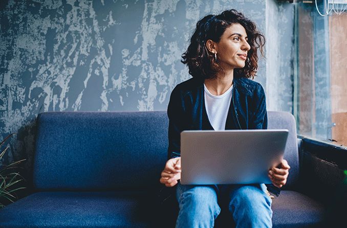 woman using the 20-20-20 rule and looking away from her laptop for 20 seconds