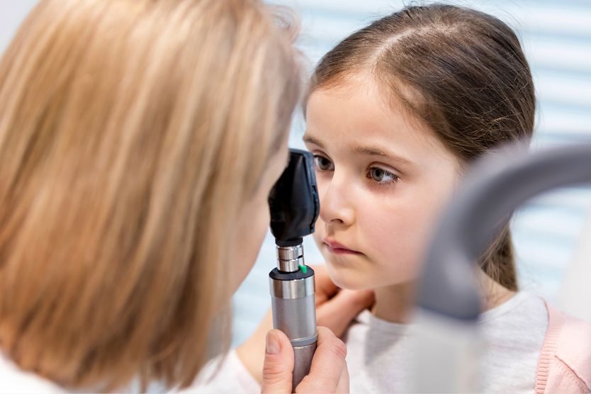 girl with nystagmus getting eyes checked by eye doctor