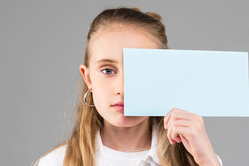 girl with nystagmus covering one eye