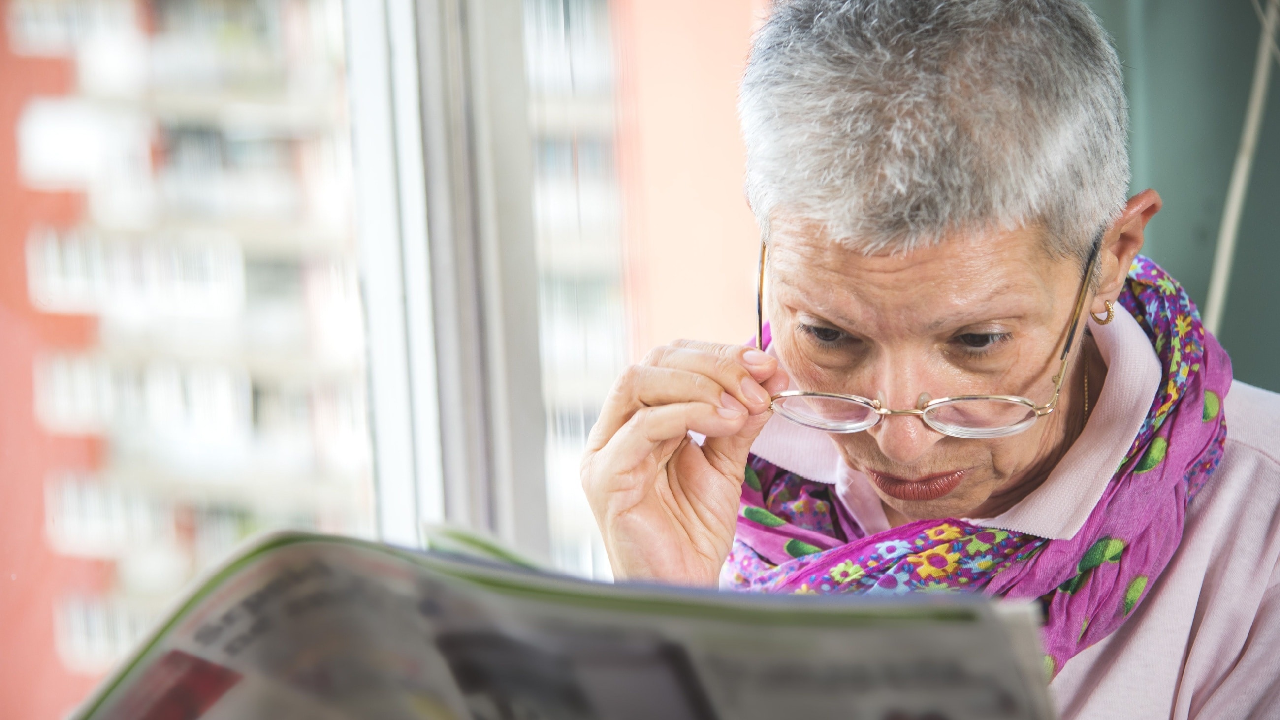 senior woman with low vision having difficulty reading senior woman with low vision having difficulty reading