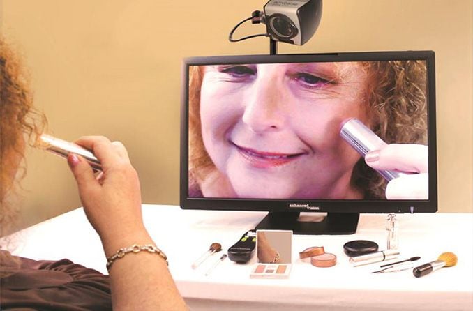 person using magnifying camera low vision aid