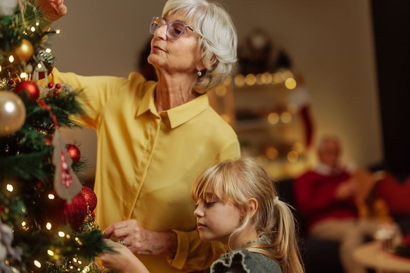 man with cataracts next to christmas tree