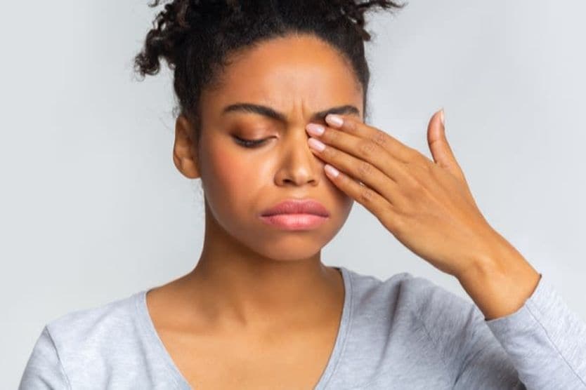 Woman with eyes closed from eye discomfort