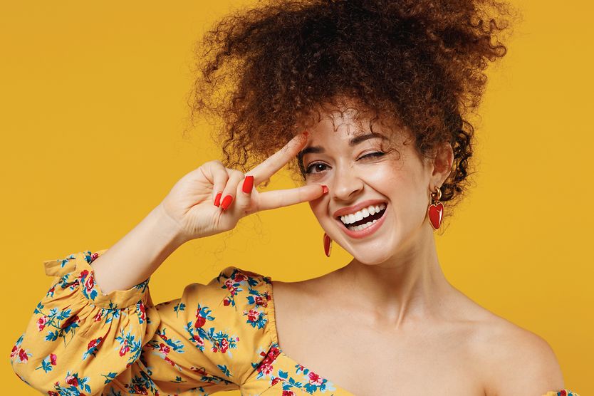 Person smiling and half blinking.