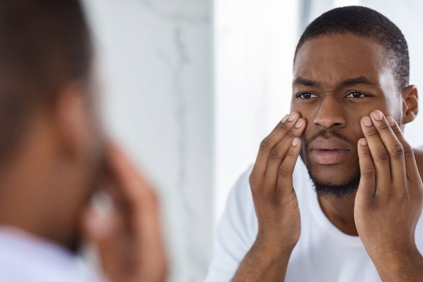 man with glassy eyes looking in the mirror man with glassy eyes looking in the mirror