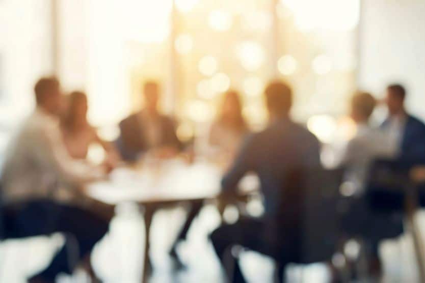 cloudy image of a people at a table