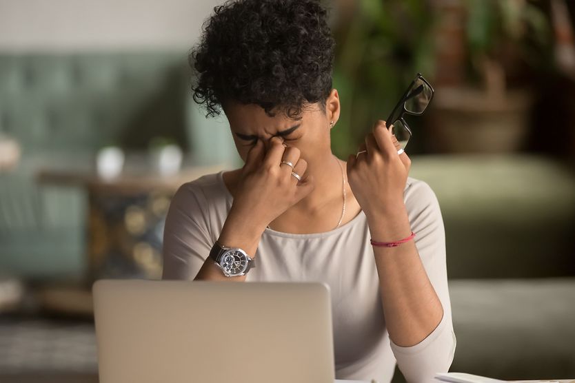 woman at computer with tired eyes