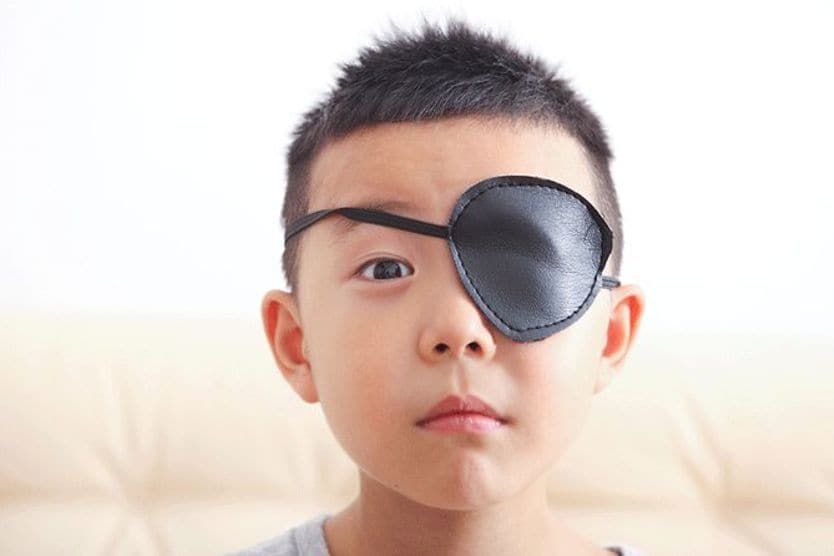 boy wearing eye patch boy wearing eye patch