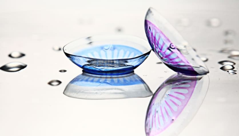 Two colored contact lenses, one for blue eyes and one for purple eyes. Two colored contact lenses, one for blue eyes and one for purple eyes.