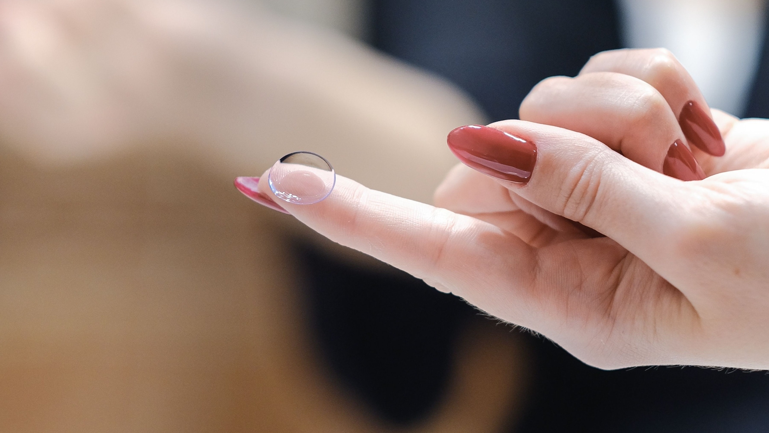 hands with long nails holding contact lens case hands with long nails holding contact lens case