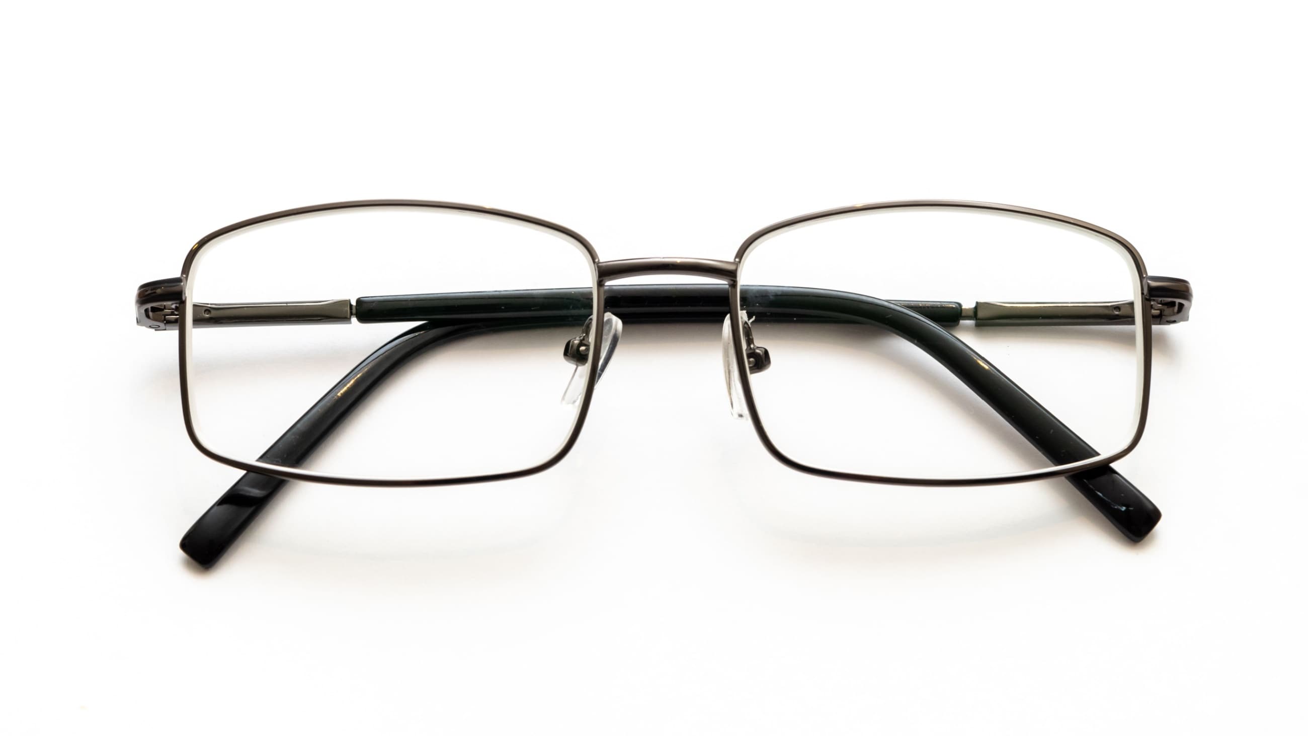 durable men's eyeglass frames placed on top of a black top