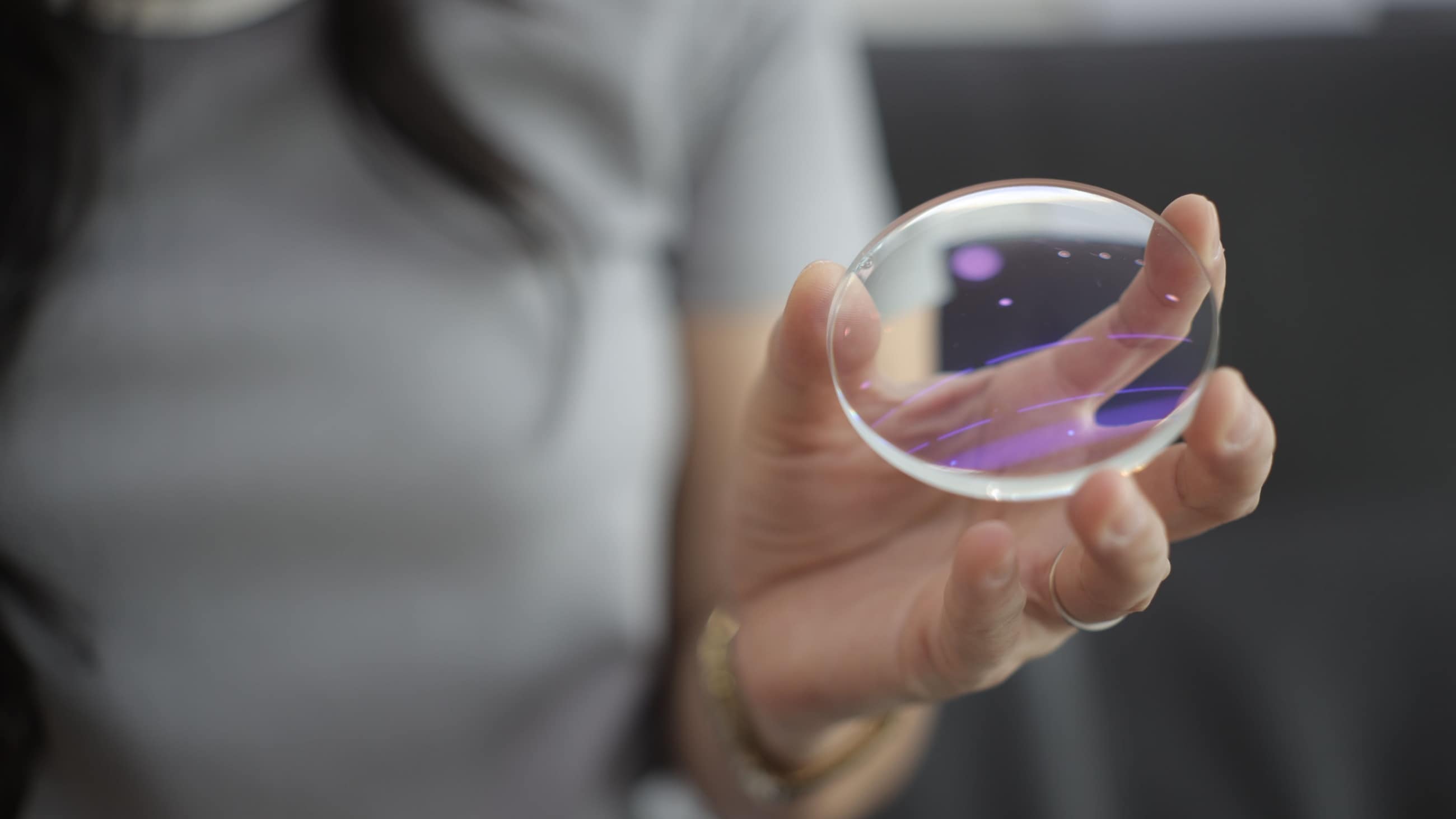 woman holding eyeglass lens