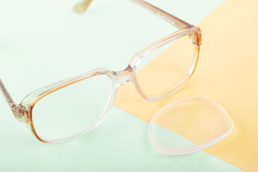 pair of eyeglasses with one lens popped out