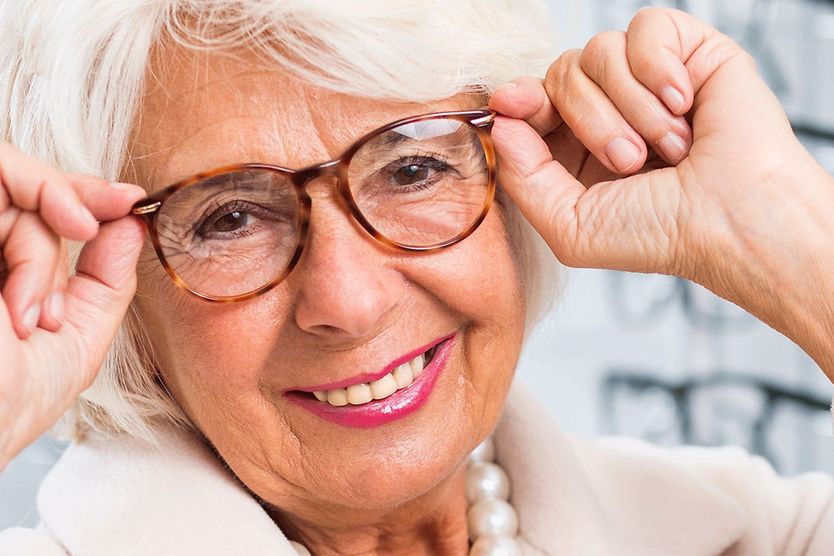 older woman trying on reading glasses and multifocals older woman trying on reading glasses and multifocals