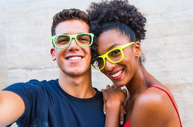 posing couple both wearing non-prescription glasses