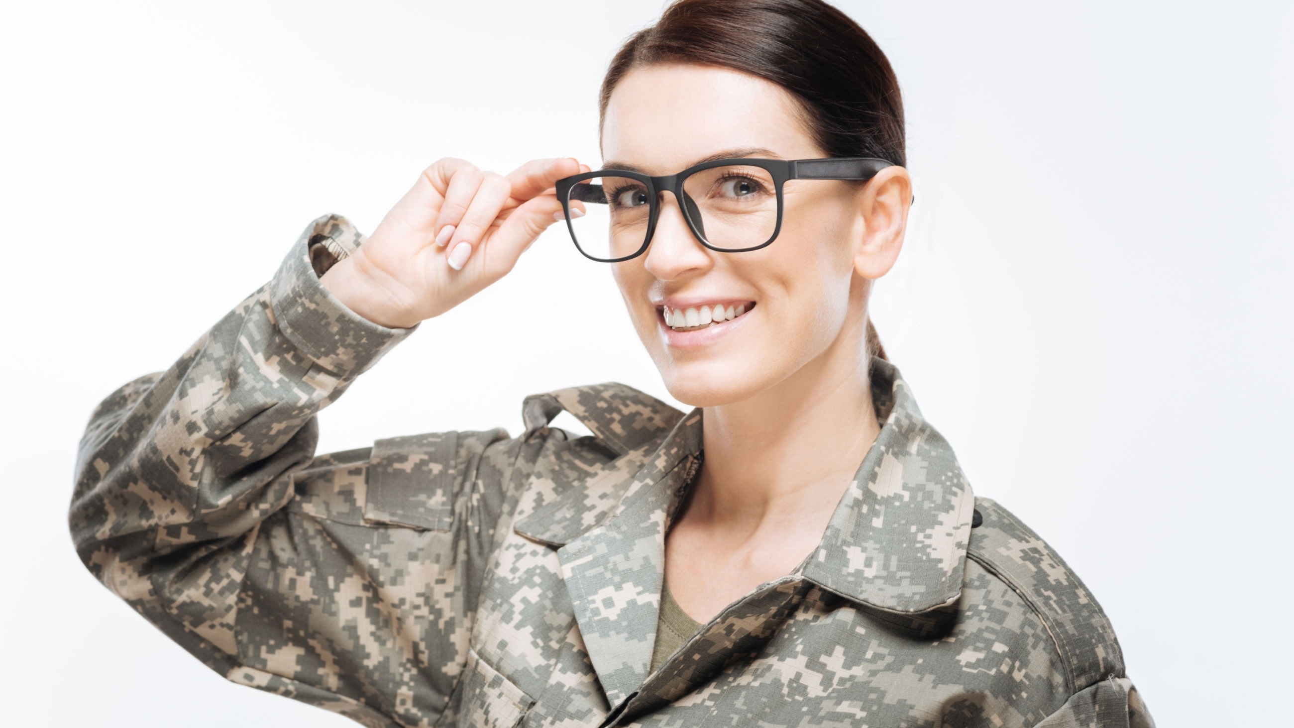 A smiling woman in a military uniform wearing glasses.