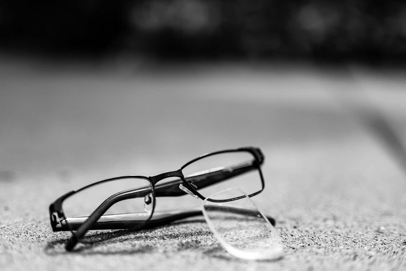Pair of glasses with lens popped out.