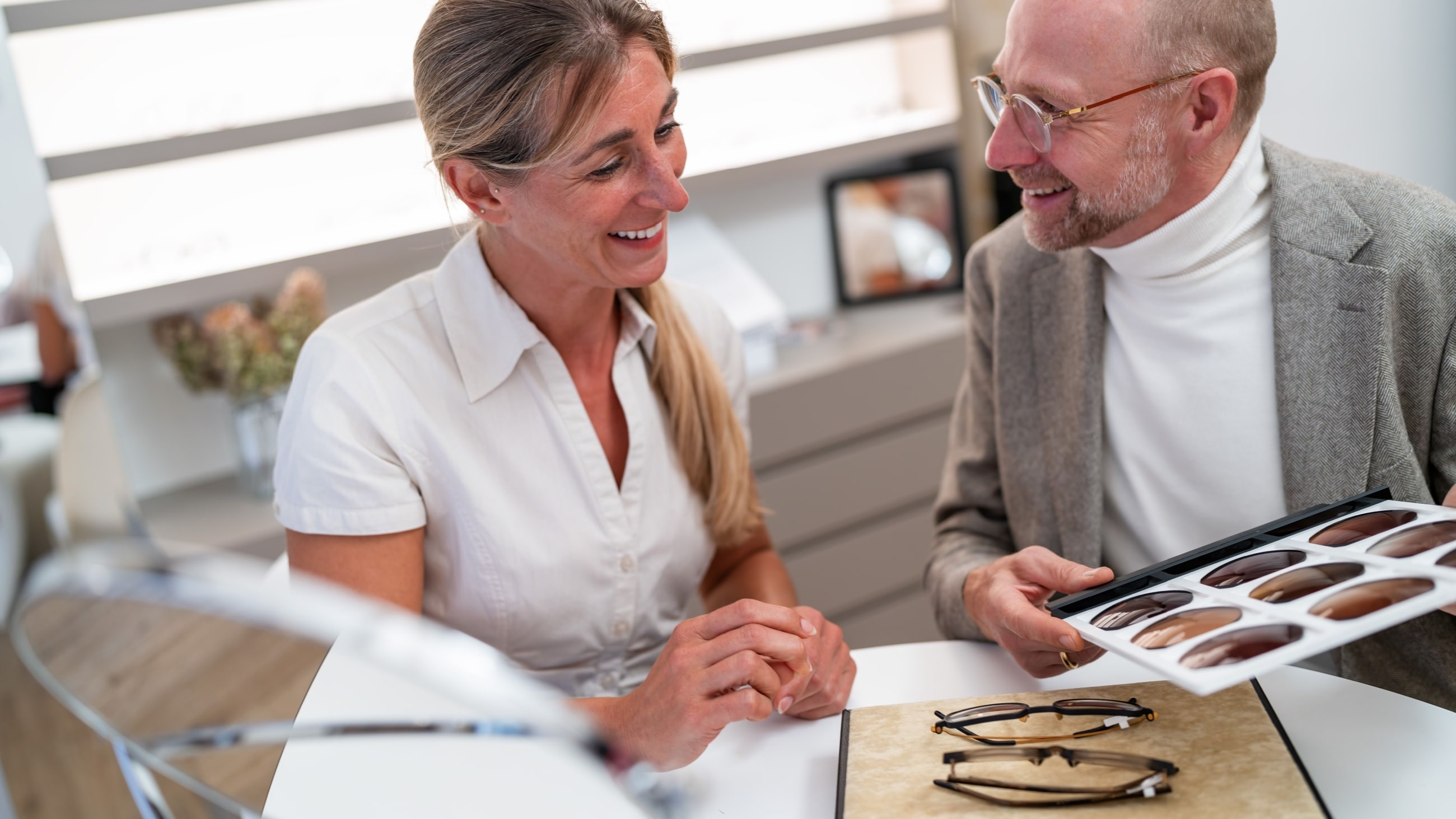 woman comparing sunglasses woman comparing sunglasses
