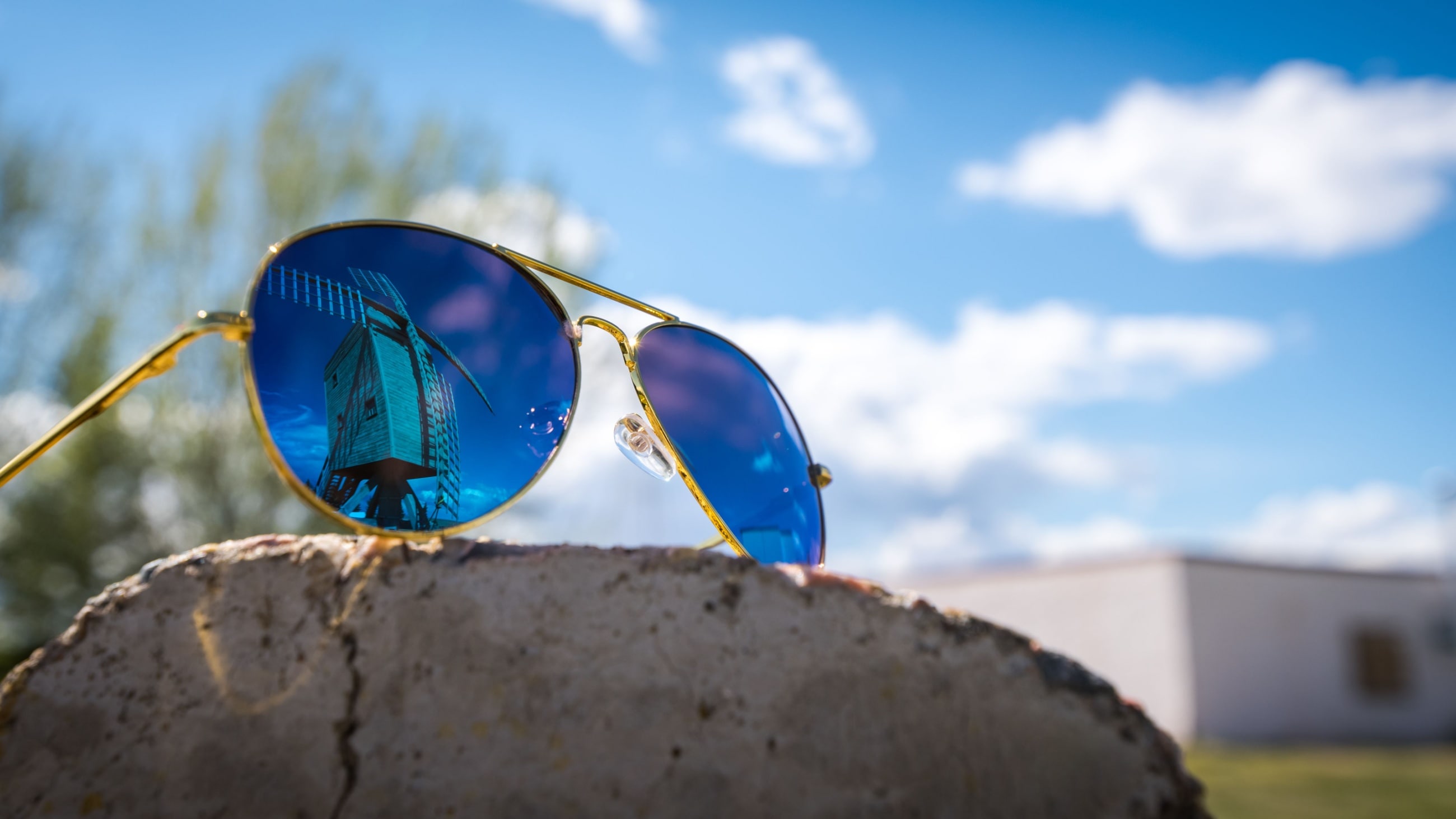 Blue-tinted Aviator sunglasses.