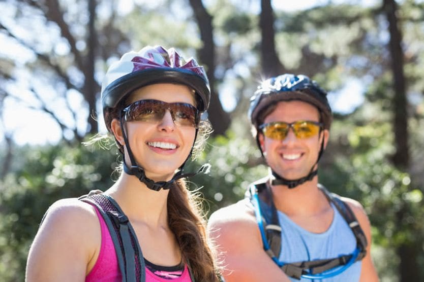 Male and female cyclists wearing wraparound sunglasses