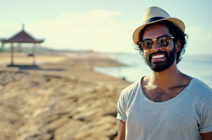 man wearing sunglasses on the beach